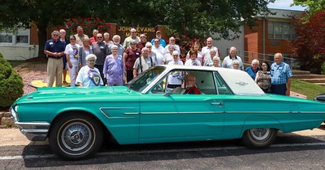 Group photo: Attendees gathered around Garry Moyers 1965 Thunderbird